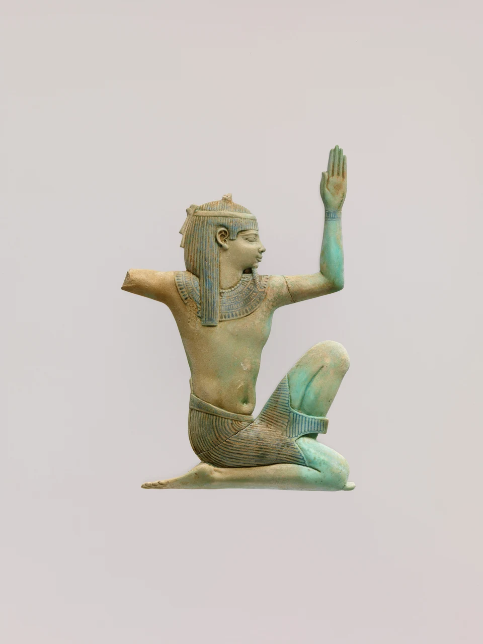Blaugrüne Fayence-Einlage mit kniender Figur des Heh; ein Arm ist erhalten und erhoben, der andere abgebrochen.